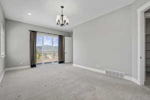 Main level off family room, 1 of  the 3 total ensuite primary bedrooms,  sliding doors to back decking