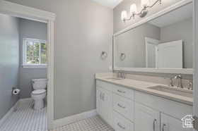 Full bath with double vanity and toilet