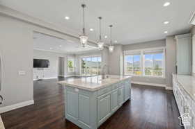 Kitchen featuring pendant lighting, an island with sink, healthy amount of natural light, open floor plan, and recessed lighting
