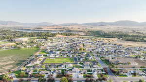 Aerial overview of property's location featuring mountains, nearby suburban area, and rural landscape
