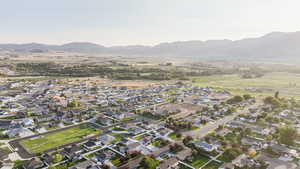 Aerial view of property's location with nearby suburban area and a mountain backdrop
