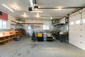 Garage featuring a heating unit and a garage door opener