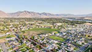 Aerial overview of property's location featuring nearby suburban area and a water and mountain view