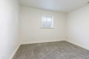 Spare room with carpet floors and baseboards