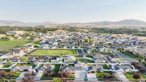 Aerial view of property's location with a mountainous background and nearby suburban area