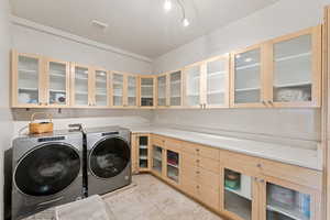 Upstairs laundry room with Bamboo cabinets and Quartz counters