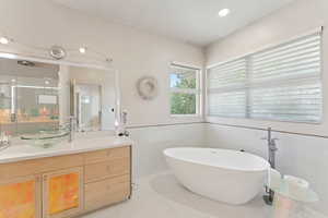 Primary bathroom with soaker tub, heated floors, Bamboo cabinets and Quartz counters, and a large rain shower!
