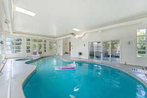 Indoor heated swimming pool and hot tub area with a diving board!
