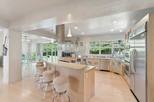 Spacious kitchen with Bamboo flooring and cabinets, Quartz counters, bar area, and Kitchen Air Pro Series appliances included