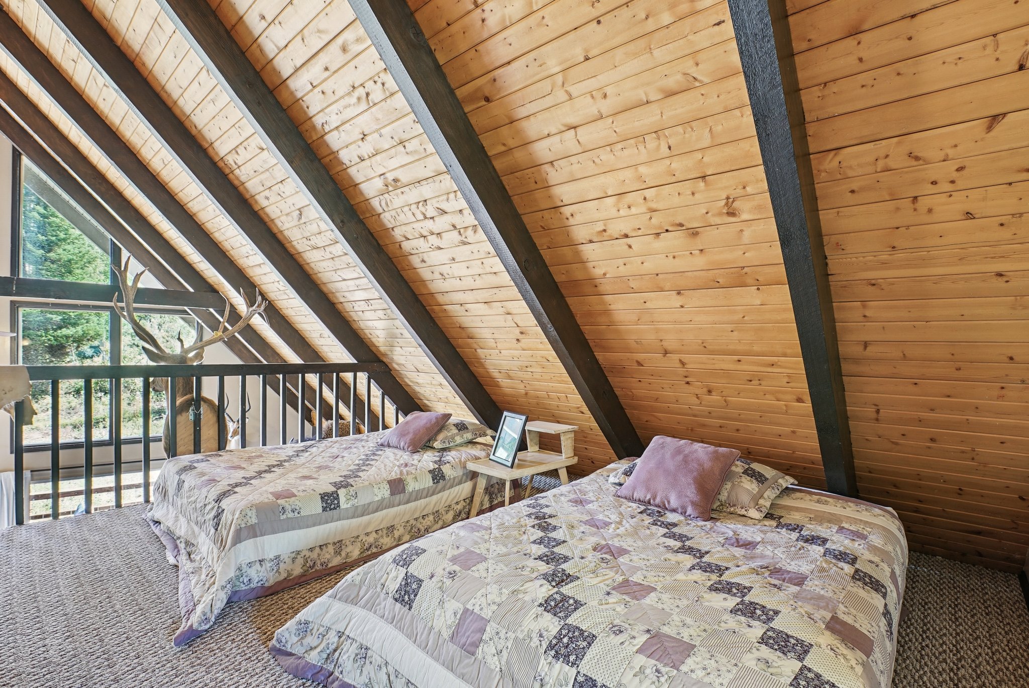 Bedroom with carpet floors and wooden ceiling