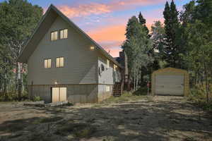 View of home's exterior featuring an outbuilding and stairs