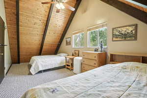 Carpeted bedroom with wood ceiling and ceiling fan