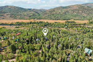 Aerial overview of property's location featuring a mountain backdrop