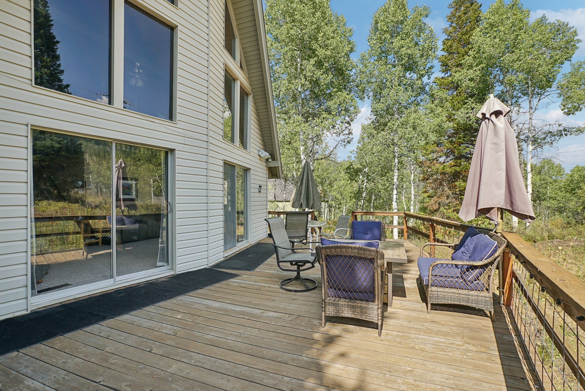 Wooden terrace with view of wooded area