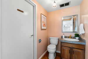 Half bath featuring vanity and toilet