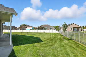 Fenced backyard with a residential view and a patio area
