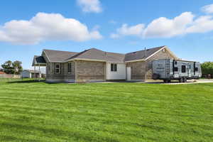 Back and side view of home with side RV pad