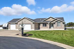 View of front of home & 3 car garage + RV