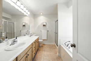 Full bathroom with a shower, double vanity, a garden bath