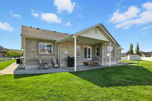 Back of property with a covered patio