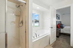Ensuite bathroom with a marble finish shower, and a garden tub
