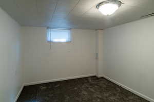 Basement featuring carpet and baseboards
