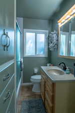 Bathroom featuring vanity and enclosed tub / shower combo
