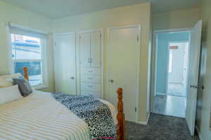Bedroom featuring carpet floors and baseboards