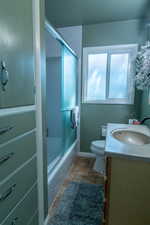 Full bathroom featuring shower / bath combination with glass door, vanity