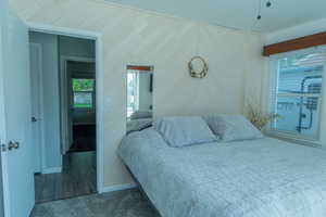 Bedroom with multiple windows, carpet floors,
