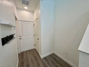 Corridor with baseboards and dark wood-style flooring