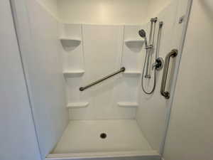 Full bathroom featuring a shower stall