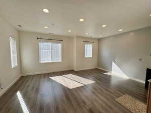 Spare room featuring wood finished floors, a textured ceiling, and recessed lighting