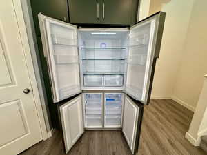 Detailed view of wood finished floors and fridge