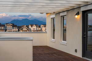 Balcony with a residential view and a deck with mountain view