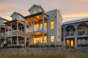 Back of house with stucco siding and a fenced front yard