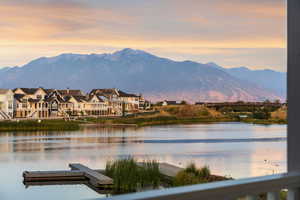 Water view featuring a mountainous background and a floating dock