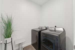 Washroom with tile patterned flooring and separate washer and dryer