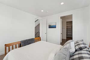 Bedroom featuring a spacious closet and recessed lighting