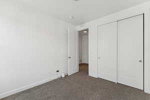 Unfurnished bedroom with carpet floors and a closet