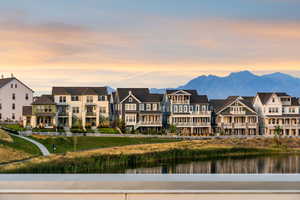 Water view featuring nearby suburban area and a mountainous background