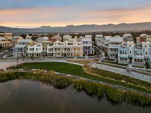 Aerial view at dusk of a residential view and a water and mountain view