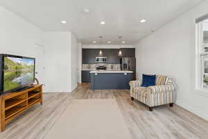 Living room featuring recessed lighting and light wood finished floors