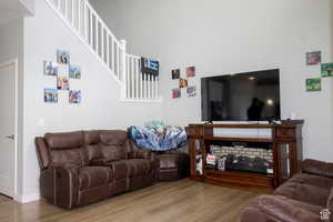Living room featuring wood finished floors and a high ceiling