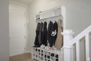 Mudroom with wood finished floors and baseboards