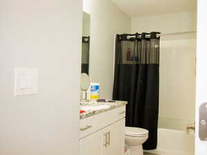 Bathroom featuring vanity and shower / tub combo with curtain