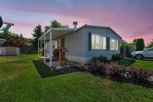 Property exterior at dusk with a storage unit