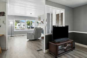 Living area with light wood-style floors and baseboards