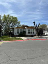 Beautifully maintained home and yard with offstreet parking, carport, outdoor retreat and two large sheds/workshops.