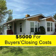 View of home's exterior with a yard